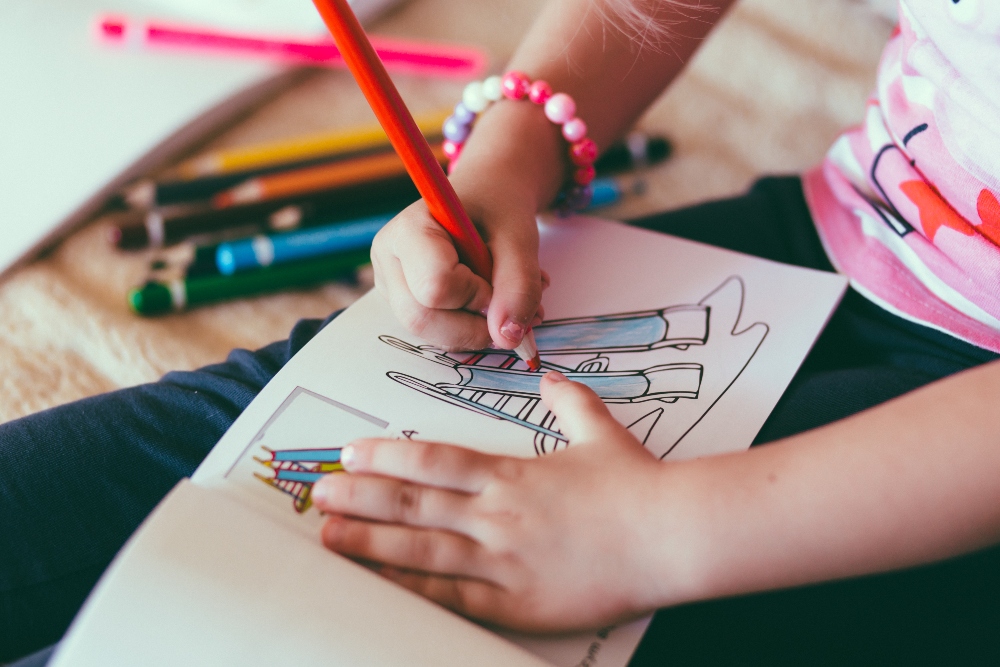 Young girl colouring a slide picture